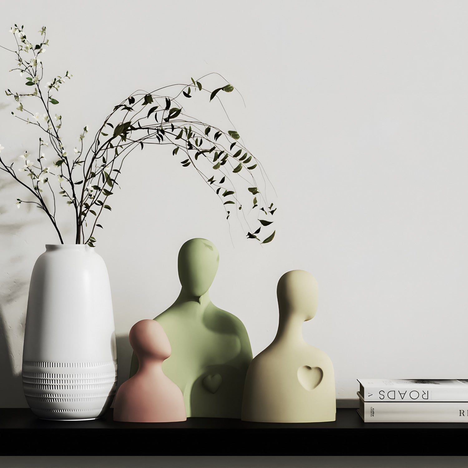 Decorative vases and a white vase with branches on a shelf against a light gray wall.